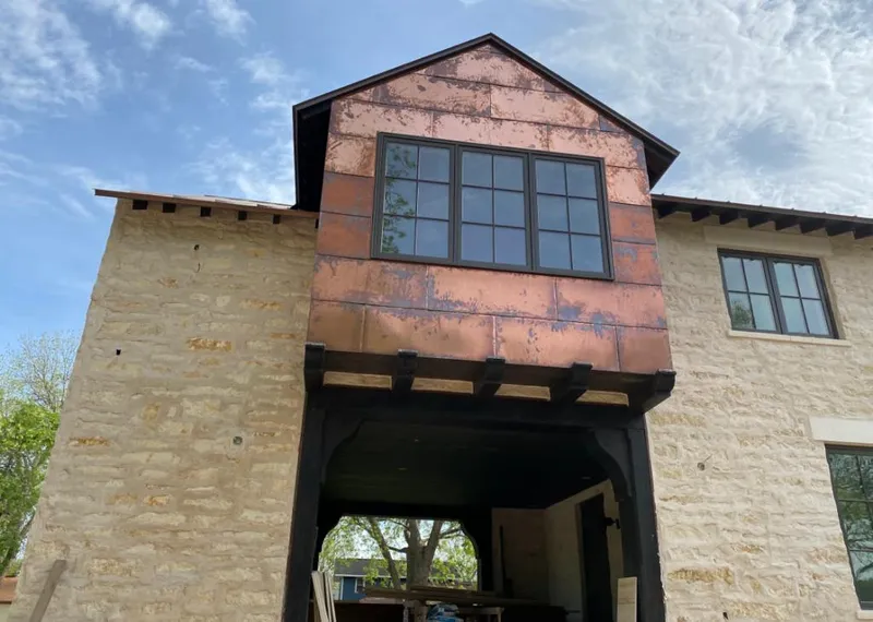 Copper metal panel facade on a stone building for Metal Roof Coating in Kenner